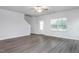 View of open floorplan living room featuring gray wood-look floors and staircase at 11360 International Dr, Middlesex, NC 27557
