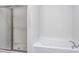 Bathroom featuring a combined shower and bathtub with glass shower door at 11376 International Dr, Middlesex, NC 27557