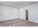 Neutral carpeted bedroom with white walls and an interior door at 11376 International Dr, Middlesex, NC 27557