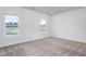 Carpeted bedroom featuring neutral walls and multiple windows at 11376 International Dr, Middlesex, NC 27557
