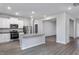 Bright kitchen features white cabinets, stainless steel appliances, granite countertops, and a large island at 11376 International Dr, Middlesex, NC 27557