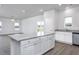 Open kitchen with granite island, stainless appliances, and abundant natural light at 11376 International Dr, Middlesex, NC 27557