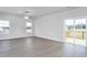 Bright living room with luxury vinyl plank flooring and sliding glass door to deck at 11376 International Dr, Middlesex, NC 27557