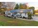 Charming home with a screened porch, lush landscaping, and a well-manicured lawn at 185 Franklin Ln, Henderson, NC 27537
