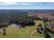 Expansive property featuring a pond, fields, and wooded areas with a clear blue sky above at 206 Pike Memory Ln, Staley, NC 27355