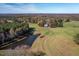 Aerial view of a charming home and acreage with a pond and forest at 206 Pike Memory Ln, Staley, NC 27355
