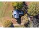 Aerial view of a home with a metal roof, nestled amongst colorful trees and a large yard at 206 Pike Memory Ln, Staley, NC 27355