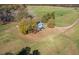 Aerial view of a charming home with mature trees, lush landscaping, and a serene, pastoral setting at 206 Pike Memory Ln, Staley, NC 27355