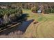 Aerial view of a charming home with a pond, acreage, and surrounding woods at 206 Pike Memory Ln, Staley, NC 27355