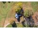 Aerial view of a home with a metal roof surrounded by colorful trees and an expansive lawn at 206 Pike Memory Ln, Staley, NC 27355