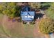 Aerial view of a charming two-story house surrounded by colorful fall foliage at 206 Pike Memory Ln, Staley, NC 27355