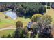 An aerial view of a charming home and acreage with a pond at 206 Pike Memory Ln, Staley, NC 27355