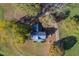 Stunning aerial view of a home with a metal roof surrounded by colorful trees and an expansive lawn at 206 Pike Memory Ln, Staley, NC 27355