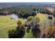 An aerial view of a charming home and acreage with a pond and barn at 206 Pike Memory Ln, Staley, NC 27355