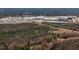 Aerial view showing natural beauty with a commercial center nearby, with great development potential at 206 Pike Memory Ln, Staley, NC 27355