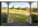 Inviting back porch with scenic views of a lush, green landscape and a tranquil pond at 206 Pike Memory Ln, Staley, NC 27355