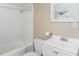 Bathroom featuring a shower-tub combo, white sink and toilet, offering a clean functional space at 206 Pike Memory Ln, Staley, NC 27355