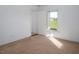 Cozy bedroom with white walls, neutral carpeting, and a view from the window at 206 Pike Memory Ln, Staley, NC 27355
