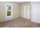 Bedroom with neutral walls, plush carpet, and a bright window, offering a cozy and inviting space at 206 Pike Memory Ln, Staley, NC 27355