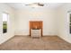 Cozy bedroom featuring carpet flooring, brick fireplace, and natural light at 206 Pike Memory Ln, Staley, NC 27355
