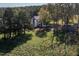 A view of the side of the home and a large yard surrounded by trees at 206 Pike Memory Ln, Staley, NC 27355