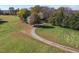 A view of the home from the driveway surrounded by a large yard and trees at 206 Pike Memory Ln, Staley, NC 27355