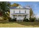 Charming two-story white farmhouse with a blue metal roof and covered front porch at 206 Pike Memory Ln, Staley, NC 27355