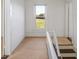 Hallway with natural light, carpeted floor, and views to the outside, offering a warm and inviting space at 206 Pike Memory Ln, Staley, NC 27355
