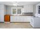 Well-lit kitchen with white cabinets, laminate countertops, and a vintage stove at 206 Pike Memory Ln, Staley, NC 27355