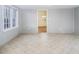 Spacious living room with light gray walls and neutral tile flooring at 206 Pike Memory Ln, Staley, NC 27355