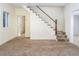 Open-concept living room with carpet, stairs, and adjacent rooms visible at 206 Pike Memory Ln, Staley, NC 27355