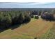 Expansive pasture bordered by mature trees offers a tranquil, bucolic setting at 206 Pike Memory Ln, Staley, NC 27355