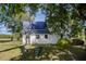 Backyard with a white farmhouse featuring a metal roof and comfortable outdoor seating at 206 Pike Memory Ln, Staley, NC 27355