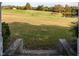 Scenic view from porch showcasing the expansive grassy yard, trees, and pond at 206 Pike Memory Ln, Staley, NC 27355
