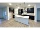 Modern kitchen featuring dark cabinetry, white countertops, and a large island at 109 S Stone Mill W Trl # 238, Clayton, NC 27520