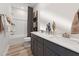 Bathroom with double sink vanity, framed mirrors, and tiled shower with white subway tiles at 1239 Shaw View Alley # 201, Raleigh, NC 27601