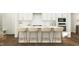 Kitchen boasts a white island with four light beige stools at 1308 Shearwater Way # 188, Knightdale, NC 27545