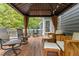 Covered patio with wood furniture, string lights, and natural views at 2725 Penfold Ln, Wake Forest, NC 27587