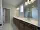 Bathroom boasts dual sinks, a large mirror, and granite countertops at 409 Marthas View Way, Wake Forest, NC 27587