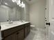 Bathroom features double sinks, marble flooring, and a large mirror with stylish lighting at 409 Marthas View Way, Wake Forest, NC 27587