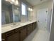 Bathroom boasts dual sinks, a large mirror, and granite countertops at 409 Marthas View Way, Wake Forest, NC 27587