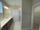 Bathroom boasts dual sinks, a large mirror, and granite countertops at 409 Marthas View Way, Wake Forest, NC 27587