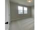 Bright bedroom featuring two windows and plush carpeting at 409 Marthas View Way, Wake Forest, NC 27587