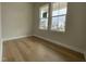 Well-lit bedroom with wood flooring and windows overlooking a construction site at 409 Marthas View Way, Wake Forest, NC 27587