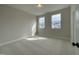 A carpeted bedroom with neutral walls and two windows allowing ample natural light at 409 Marthas View Way, Wake Forest, NC 27587