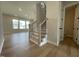 Inviting entryway features wood staircase and view into living room with natural light at 409 Marthas View Way, Wake Forest, NC 27587