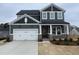 Charming two-story home features an attached two-car garage and stone accents at 409 Marthas View Way, Wake Forest, NC 27587