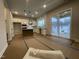 Bright, unfinished kitchen featuring a center island, white cabinets, stainless steel appliances, and sliding door to the backyard at 409 Marthas View Way, Wake Forest, NC 27587