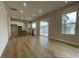 Open-concept kitchen and living room with hardwood floors and an island at 409 Marthas View Way, Wake Forest, NC 27587