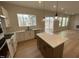 Well-lit kitchen with center island, stainless appliances, and an open layout with seamless access to the living spaces at 409 Marthas View Way, Wake Forest, NC 27587